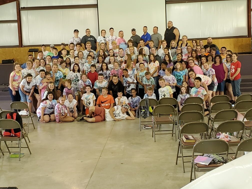 Campers and staff gathered for a group photo in matching camp T-shirts