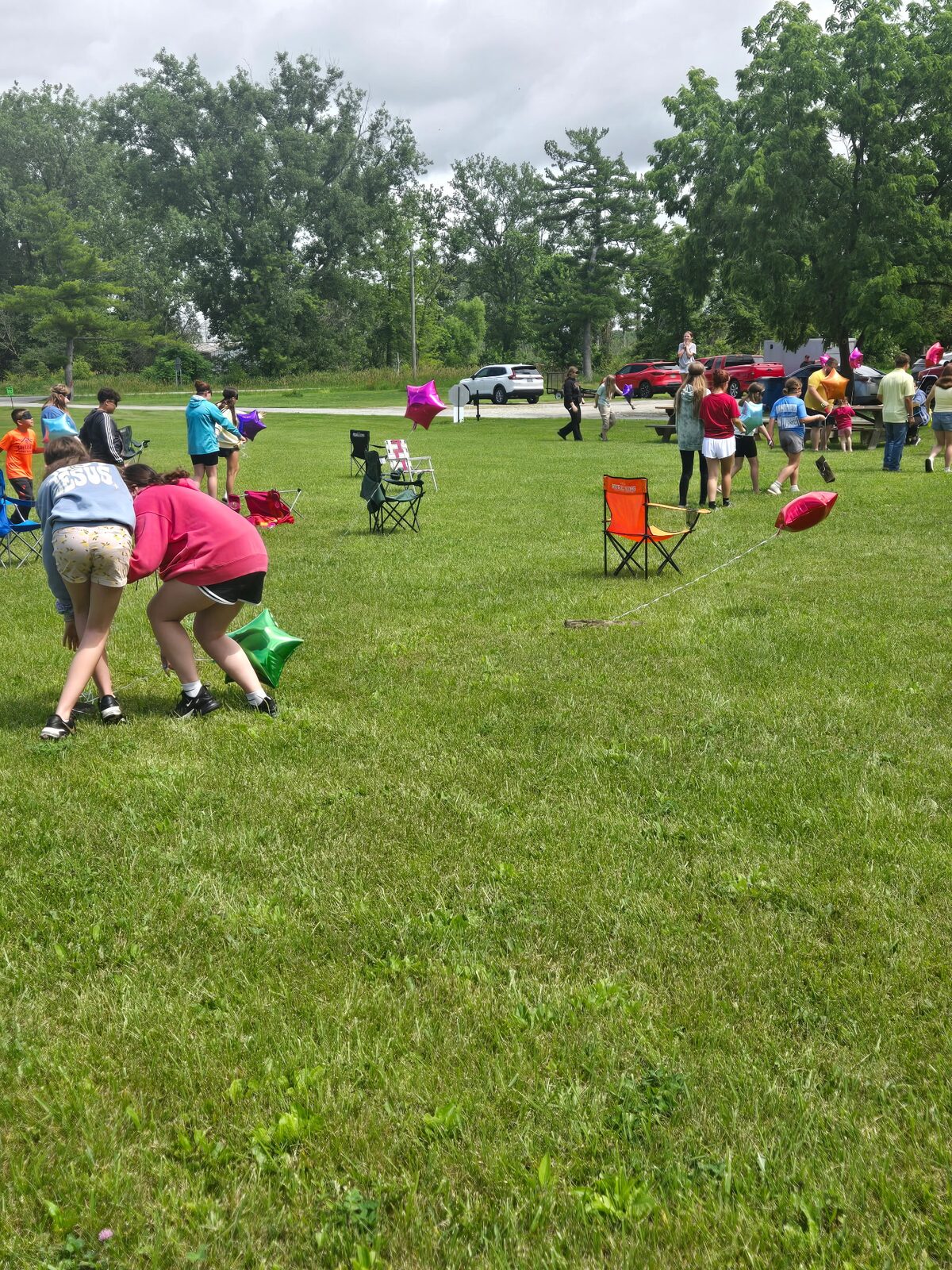 Campers playing a balloon game in the field