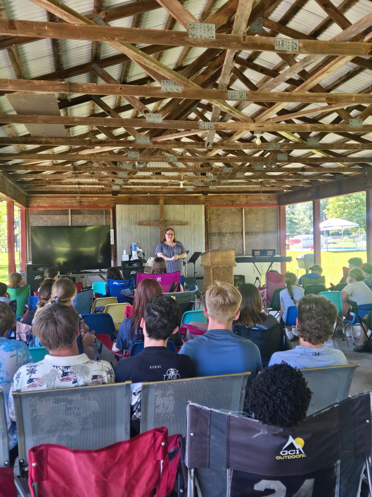 A speaker teaching campers in the open-air pavilion