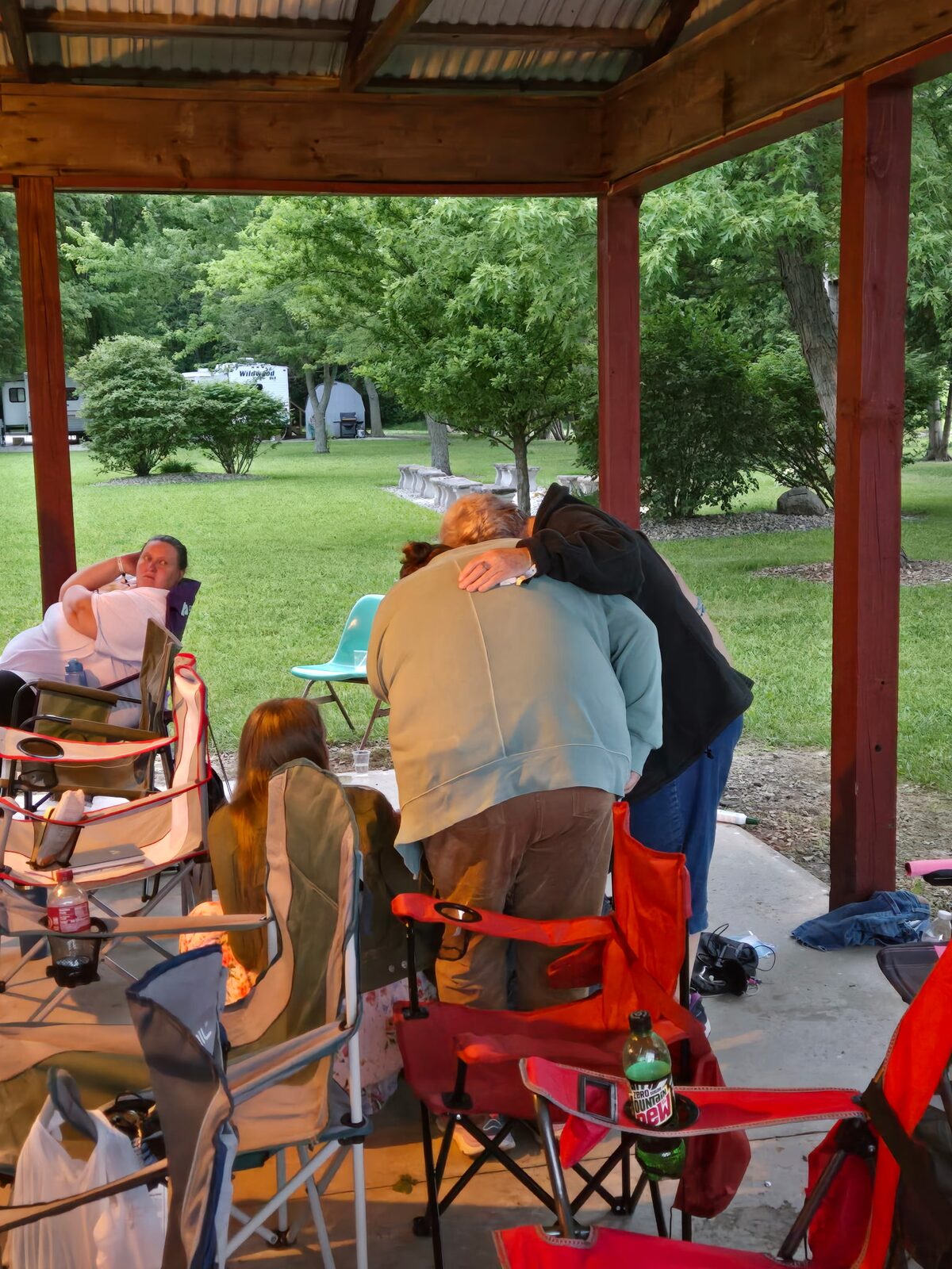 Camp staff and campers praying together at the pavilion